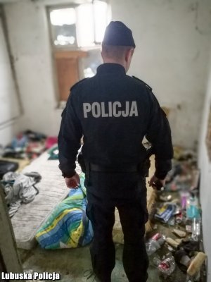 Na zdjęciu widać policjanta sprawdzającego pustostany.