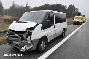 rozbity biały bus, widok na przód pojazdu stojącego na poboczu