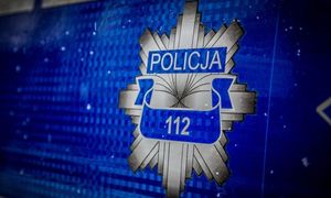 Naklejka z radiowozu z policyjnym logo i napisem: &quot;Policja 112&quot;