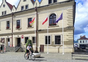 Policjant na rowerze przed ratuszem.