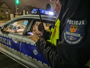 Policjanci kontrolujący trzeźwość na drodze, wyniki na urządzeniach.