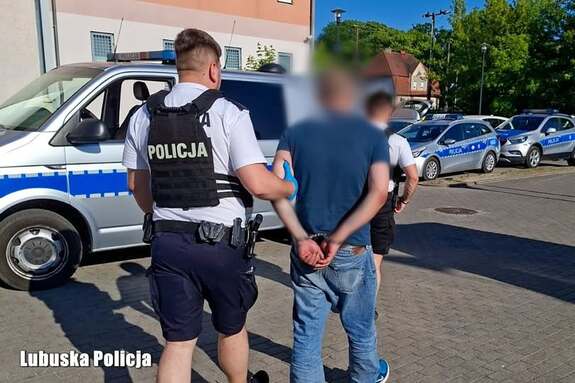 policjanci prowadzą zatrzymanego